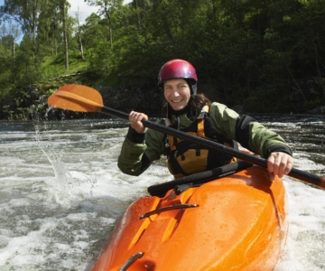 hybrid hearing man on kayak